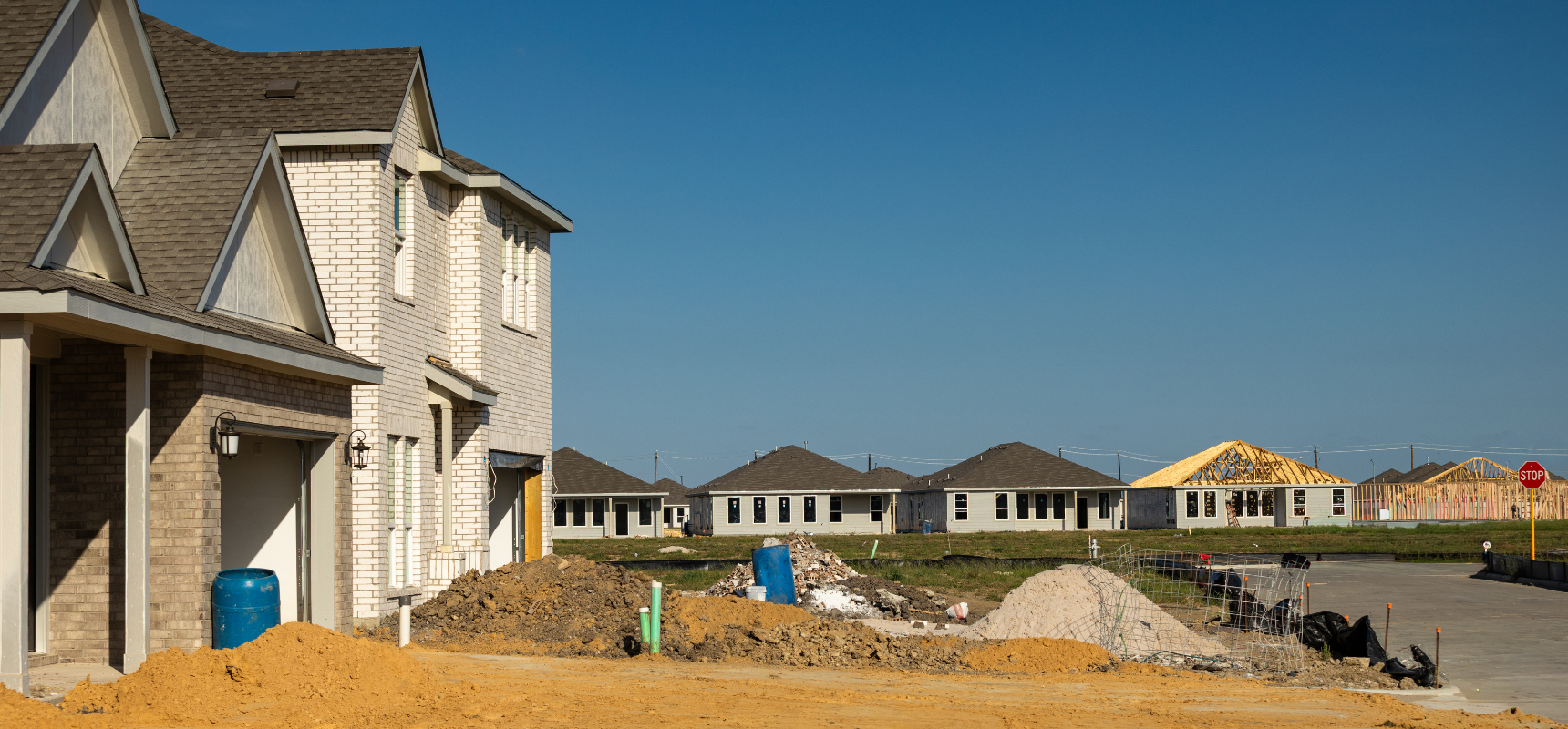 A neighborhood of new construction houses being built from the ground up.