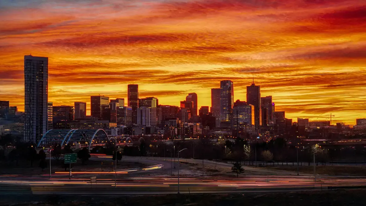 Denver skyline at sunset representing 2025 real estate investment trends, market growth, and neighborhood opportunities for investors.
