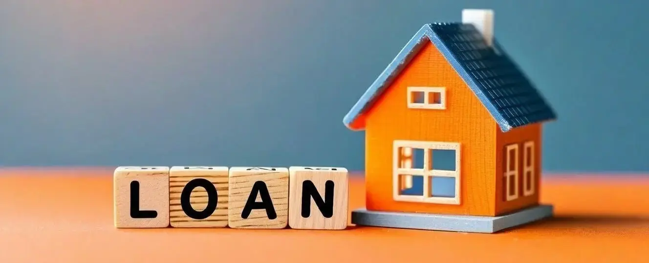 Miniature house beside wooden blocks spelling 'loan,' representing private money loans for real estate investors.
