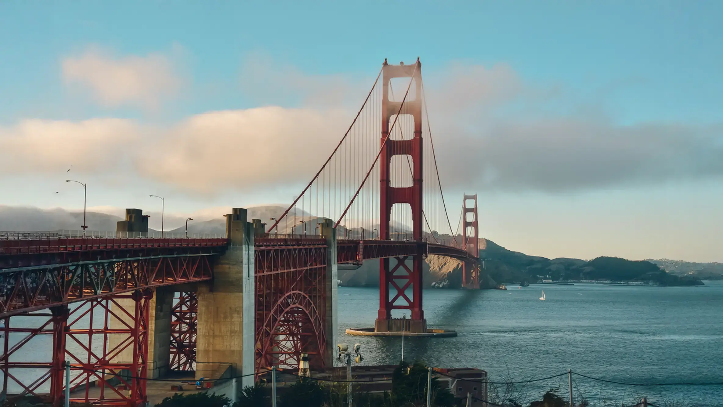 San Francisco real estate investment trends represented by a panoramic view of the Golden Gate Bridge on a partly sunny day.