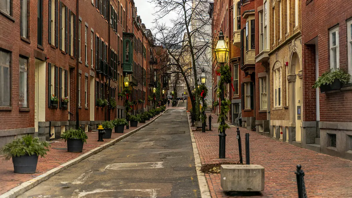 Historic Boston street lined with brick rowhouses, representing neighborhoods where investors use short term real estate loans for renovation and redevelopment projects.